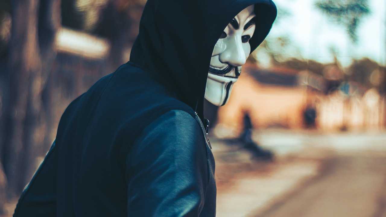 A masked person flees.